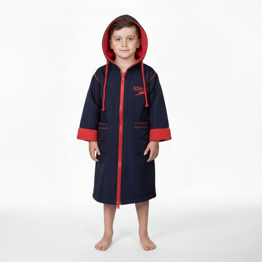 Child wearing a navy and red robe on a white background