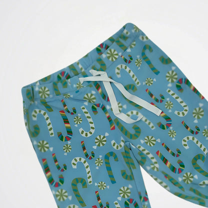 Blue pajama pants with candy cane pattern on a white background